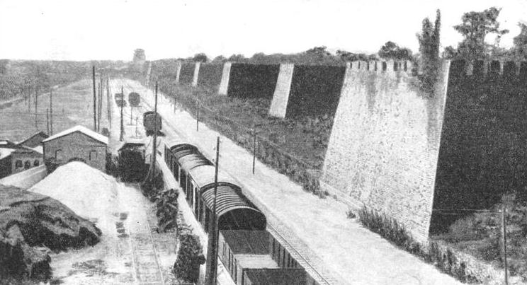 The old city wall at Peking with the railway track laid alongside it