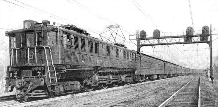 AN EXPRESS PASSENGER train of the Pennsylvania Railroad drawn by a modern electric locomotive