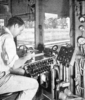 THE RECORDING OPERATOR watches the track from the rear of the moving car