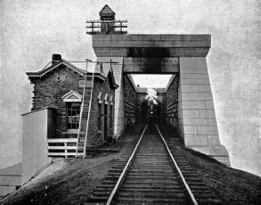 TRAIN EMERGING FROM THE OLD VICTORIA TUBULAR BRIDGE 