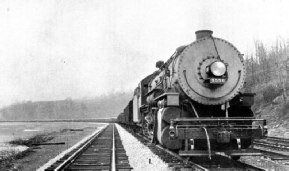 LONG FREIGHT TRAIN HAULED BY LOCOMOTIVE WITH BOOSTER