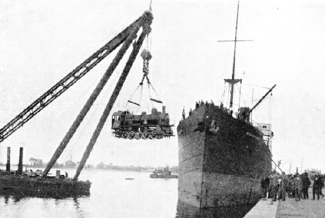 A large locomotive being unloaded at the Riga docks for transportation to Russia