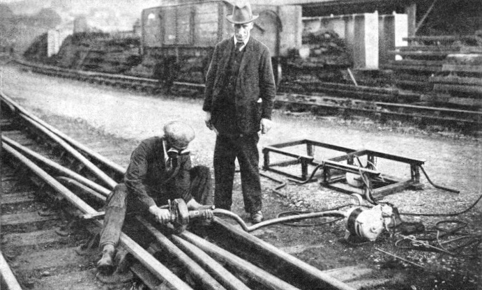 A rail being brought to the correct profile after electric-arc welding