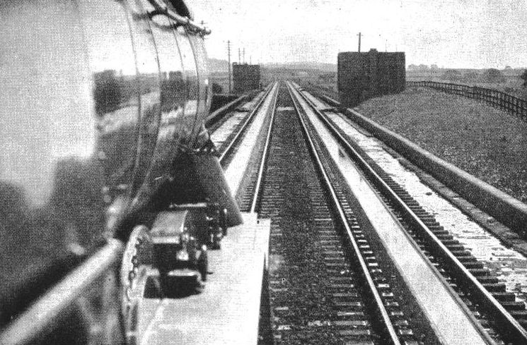 A long drink: a locomotive picking up water at speed