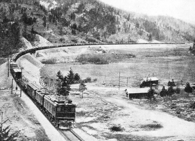 LARGE ELECTRIC LOCOMOTIVES, such as those shown above, now haul the huge freight trains through the mountains