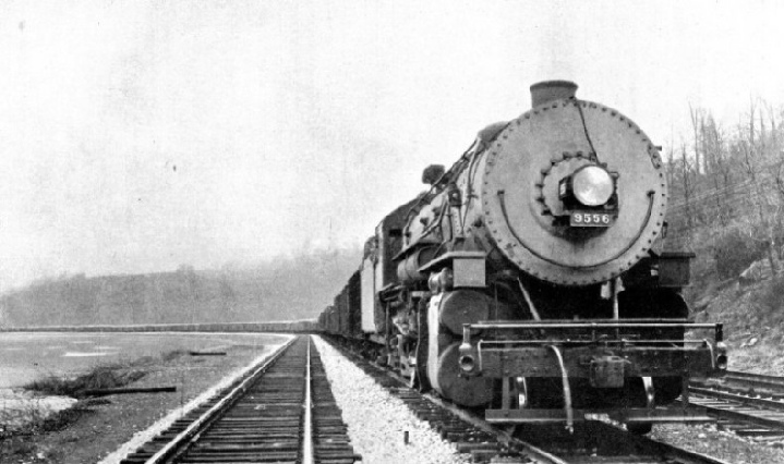 LONG FREIGHT TRAIN HAULED BY LOCOMOTIVE WITH BOOSTER