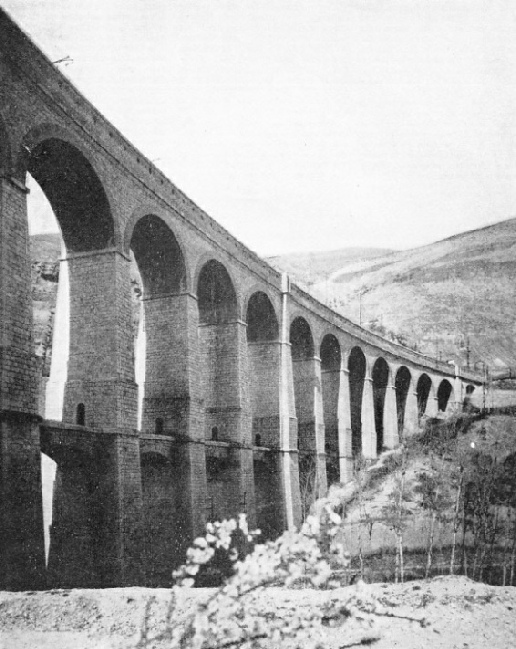 ON THE ROME-SULMONA ROUTE. The line has been electrified, and the standards supporting the overhead conductors can be seen on the viaduct