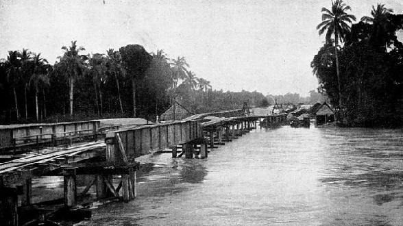 The Muda River in Kedah overflowing its banks, threatening a bridge-building site