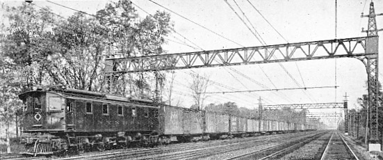 MAIN LINE ELECTRIC FREIGHT LOCOMOTIVE AND TRAIN ON THE NEW YORK, NEW HAVEN AND HARTFORD RAILROAD