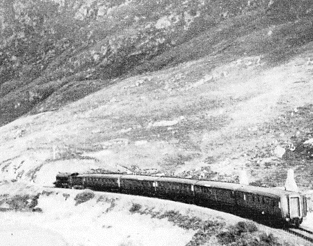 A WEST HIGHLAND TRAIN passing below Creag Mhor (the Great Rock), between Arisaig and Morar
