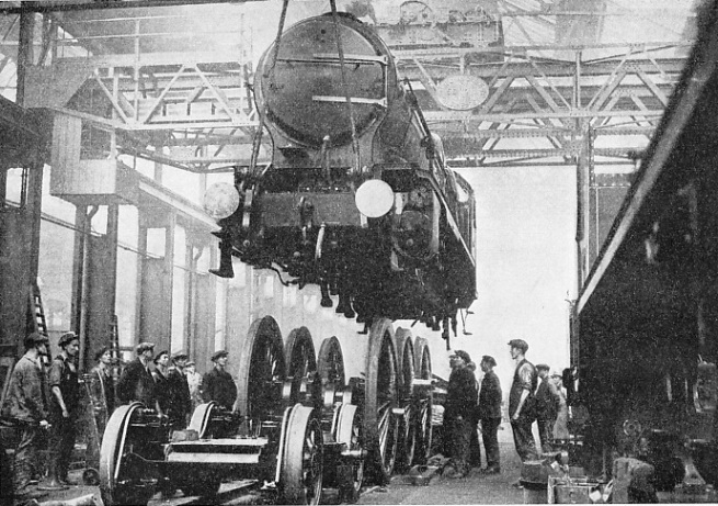 Raising an express passenger engine off its wheels for the purpose of an overhaul at the Southern Railway’s works at Eastleigh