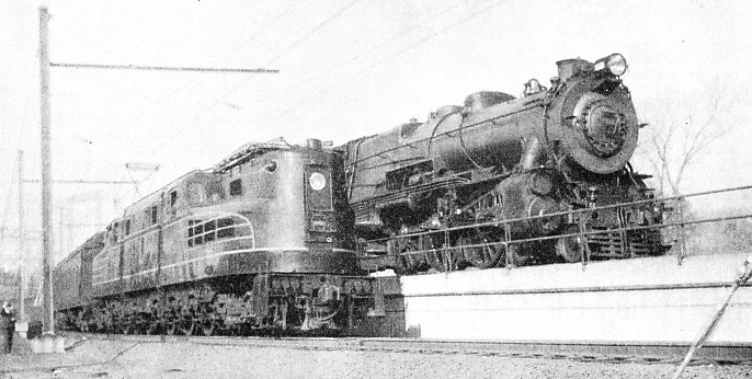 One of the latest streamlined electric locomotives of the Pennsylvania Railroad alongside a standard “Pacific”