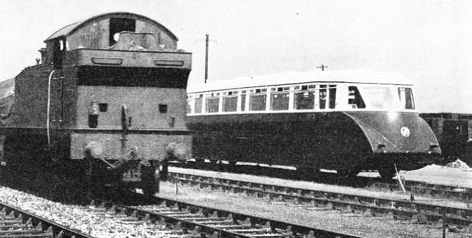 A striking contrast is presented by this juxtaposition of a Great Western Rail Coach and a tank engine