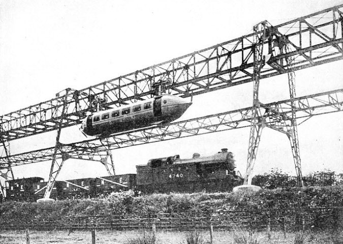 The cars are suspended from bogies running on an overhead rail